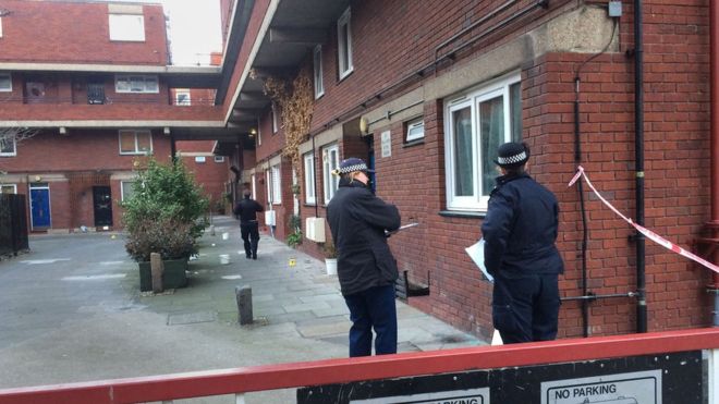 Police at the scene of a stabbing at Bartholomew Court, Old Street
